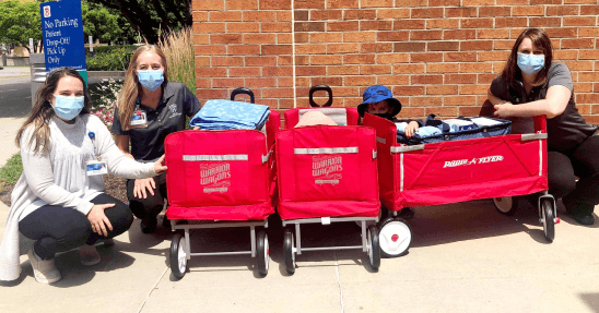 Volunteers sitting with a few Warrior Wagons