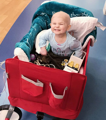 Child smiling in her Wagon