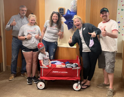 Group smiling with their Warrior and Wagon