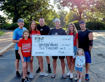 Group holding a giant check