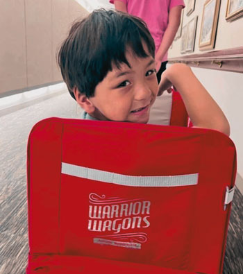 Child smiling in Warrior Wagon